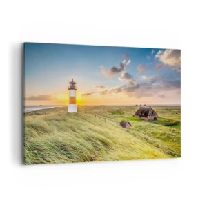 Impression sur toile - Image sur toile - Un phare avec des prairies et des maisons au soleil en arrière-plan - 100x70cm - Entre les vagues - Décoration murale moderne pour le salon et la chambre ARTTOR