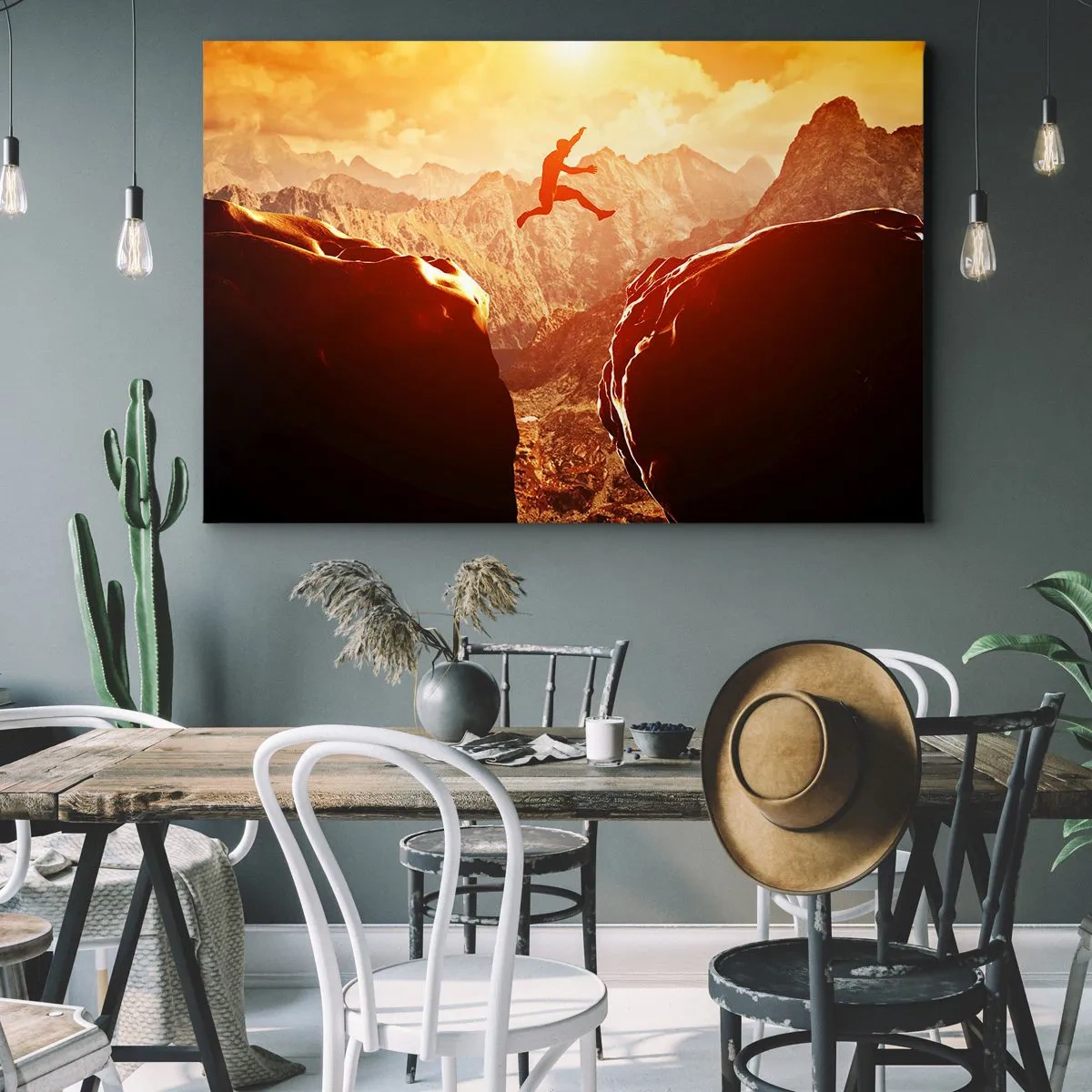 Impression sur toile - Image sur toile - Une silhouette sautant entre des rochers avec des montagnes en arrière-plan - 70x50cm - Dépassement des limites - Décoration murale moderne pour le salon et la chambre ARTTOR