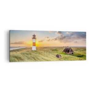 Impression sur toile - Image sur toile - Un phare avec des prairies et des maisons au soleil en arrière-plan - 140x50cm - Entre les vagues - Décoration murale moderne pour le salon et la chambre ARTTOR