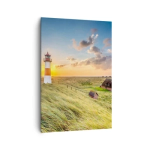 Impression sur toile - Image sur toile - Un phare avec des prairies et des maisons au soleil en arrière-plan - 70x100cm - Entre les vagues - Décoration murale moderne pour le salon et la chambre ARTTOR