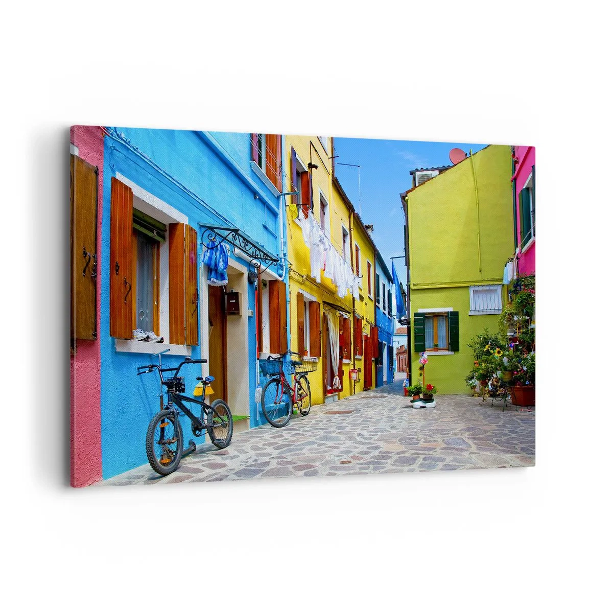 Impression sur toile - Image sur toile - Une rue colorée avec des vélos parmi des bâtiments pastel - 120x80cm - Pastel, douce ruelle - Décoration murale moderne pour le salon et la chambre ARTTOR