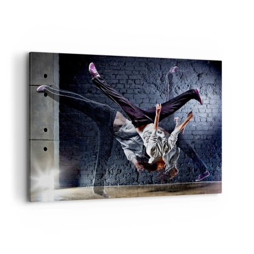 Impression sur toile - Image sur toile - Un danseur effectuant un saut dynamique contre un mur de briques - 120x80cm - Étoile de la rue - Décoration murale moderne pour le salon et la chambre ARTTOR