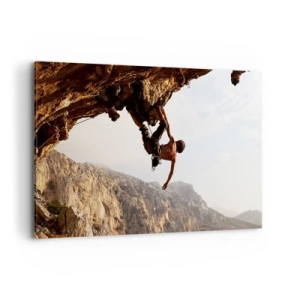 Impression sur toile - Image sur toile - Un grimpeur sur une falaise abrupte dans les montagnes au soleil - 120x80cm - Le monde rétréci dans une main sur une coupe de rocher - Décoration murale moderne pour le salon et la chambre ARTTOR