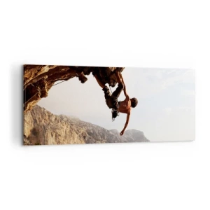Impression sur toile - Image sur toile - Un grimpeur sur une falaise abrupte dans les montagnes au soleil - 120x50cm - Le monde rétréci dans une main sur une coupe de rocher - Décoration murale moderne pour le salon et la chambre ARTTOR