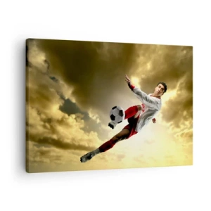 Impression sur toile - Image sur toile - Un joueur de football dans un saut dynamique frappant le ballon contre le ciel - 70x50cm - Le paradis du football - Décoration murale moderne pour le salon et la chambre ARTTOR