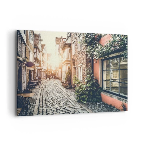 Impression sur toile - Image sur toile - Une charmante rue pavée de pierre et fleurie - 100x70cm - Allée de roses en lueur rose - Décoration murale moderne pour le salon et la chambre ARTTOR