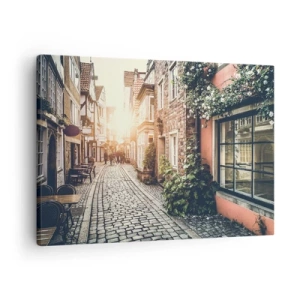 Impression sur toile - Image sur toile - Une charmante rue pavée de pierre et fleurie - 70x50cm - Allée de roses en lueur rose - Décoration murale moderne pour le salon et la chambre ARTTOR