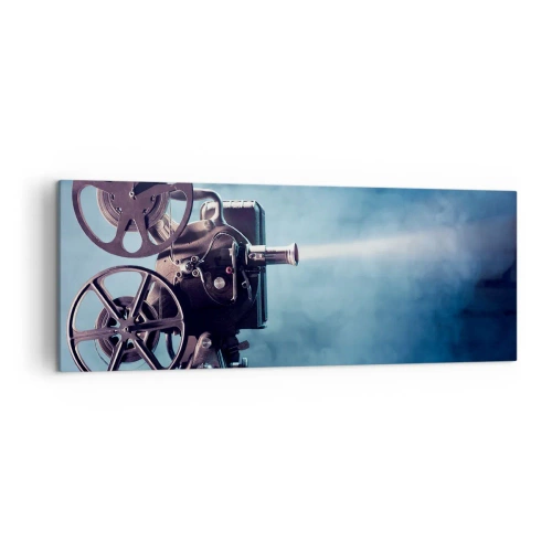 Impression sur toile - Image sur toile - Un vieux projecteur de cinéma projetant de la lumière sur un fond bleu - 140x50cm - Dans un vieux cinéma - Décoration murale moderne pour le salon et la chambre ARTTOR