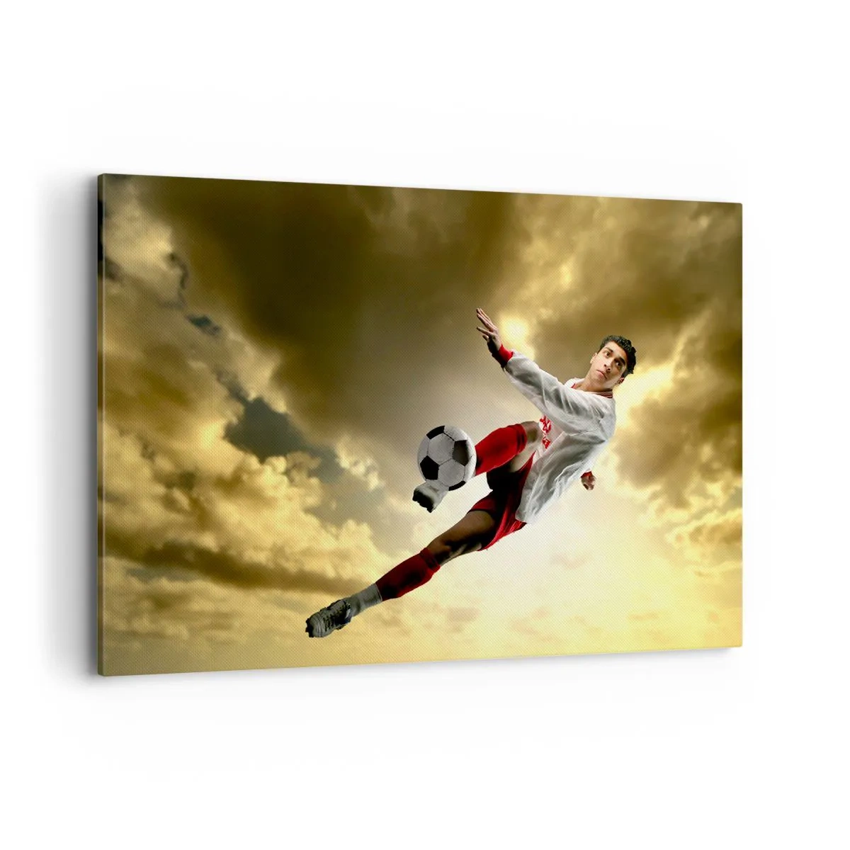 Impression sur toile - Image sur toile - Un joueur de football dans un saut dynamique frappant le ballon contre le ciel - 120x80cm - Le paradis du football - Décoration murale moderne pour le salon et la chambre ARTTOR