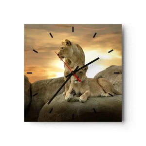 Horloge murale - Pendule murale - Deux lionnes se reposant sur un rocher au coucher du soleil - 30x30cm - Majesté royale - Décoration murale moderne pour le salon et la chambre ARTTOR
